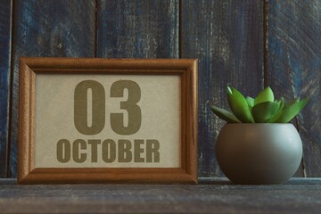 Wall Mural - october 3rd. Day 3 of month, date in frame next to succulent on wooden background autumn month, day of the year concept