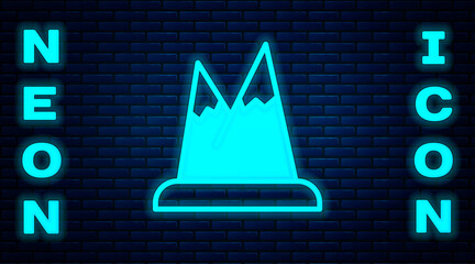 Poster - Glowing neon Mountains icon isolated on brick wall background. Symbol of victory or success concept. Vector.