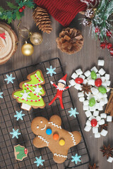 Wall Mural - Merry Christmas. The making of gingerbread for Christmas. Top view and selective focus on the gingerbread man. Vintage film grained filter applied