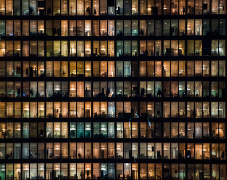 office building facade - business people working at night