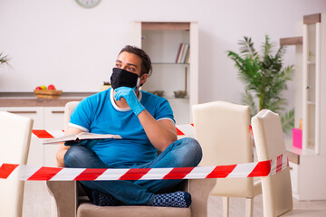 Young male student preparing for exams during pandemic at home