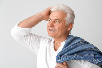 Poster - stylish senior man on grey background