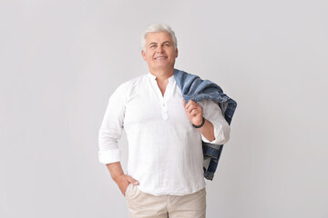 Wall Mural - Stylish senior man on grey background