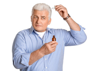 Poster - Senior man using serum for hair loss treatment on white background