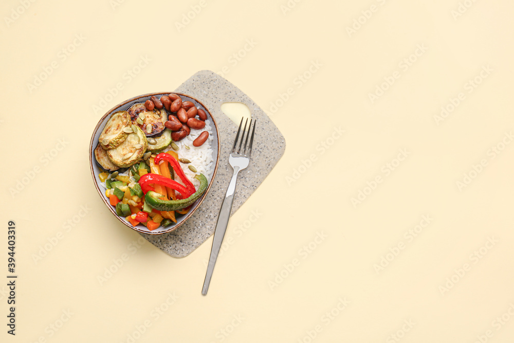 Plate of delicious rice salad with vegetables on light background