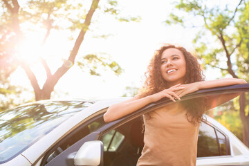 Poster - Happy African-American woman near car outdoors