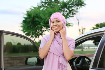 Canvas Print - Young Muslim woman near car