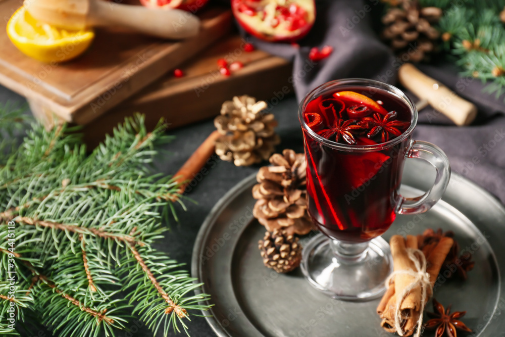 Glass cup of tasty mulled wine on table