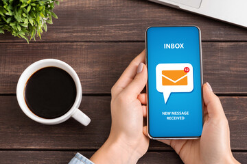 Poster - Flat lay of unrecognizable young woman checking her inbox for incoming email messages at desk during coffee break