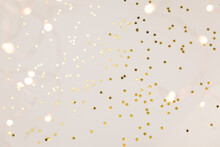 Festive Gold Background. Shining Stars Confetti And Fairy Lights On Beige And Set Sail Champagne Background. Christmas. Wedding. Birthday. Flat Lay, Top View, Copy Space