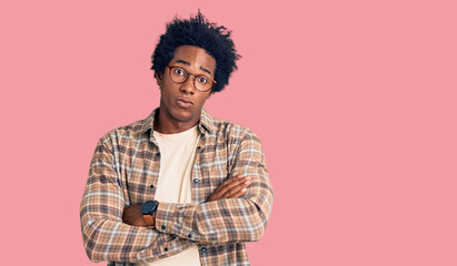 Sticker - Handsome african american man with afro hair wearing casual clothes and glasses skeptic and nervous, disapproving expression on face with crossed arms. negative person.