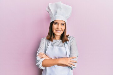 Canvas Print - Young blonde woman wearing professional cook uniform and hat shouting with crazy expression doing rock symbol with hands up. music star. heavy concept.