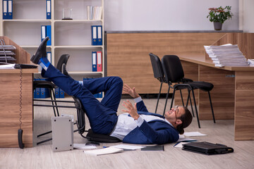 Wall Mural - Young male businessman employee unhappy with his work