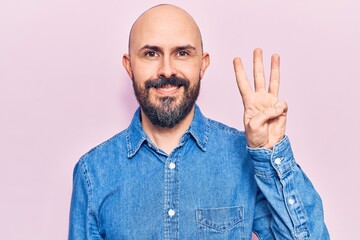 Poster - Young handsome man wearing casual clothes showing and pointing up with fingers number three while smiling confident and happy.