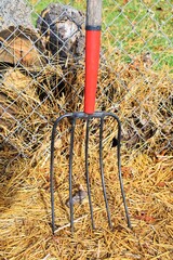 Wall Mural - Pitchfork and Straw by a Chain Link Fence