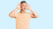 © Krakenimages.com - Young handsome man wearing casual clothes smiling cheerful playing peek a boo with hands showing face. surprised and exited