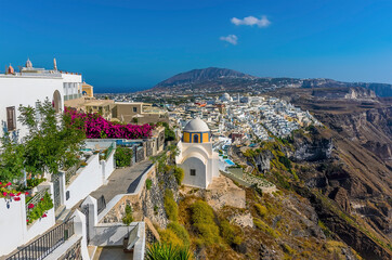 Wall Mural - A view from the path over the city of Thira, Santorini towards the mountain Profitis Ilias in summertime
