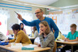 © Johnér - Teacher helping girl in classroom, Sweden