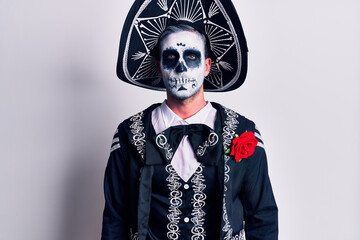 Sticker - Young man wearing mexican day of the dead costume over white relaxed with serious expression on face. simple and natural looking at the camera.