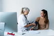© Johnér - Doctor checking patients blood pressure, Sweden