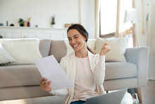 Yes. Overjoyed Young Woman Remote Employee Reading Paper Letter From Company Informing She Is Hired On Vacant Place, Happy Millennial Lady Bank Client Getting Loan Mortgage Credit Application Approval