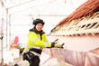 © Johnér - Woman working on roof, Sweden