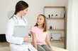 © White bear studio  - Young girl doctor pediatrician makes a checkup to a little girl