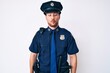 © Krakenimages.com - Young caucasian man wearing police uniform making fish face with lips, crazy and comical gesture. funny expression.