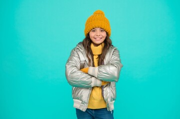 Wall Mural - Warm smiles. teenage girl in silver puffer jacket. trendy warm clothing. happy childhood. accessories shop for kids. enjoy weather on christmas holidays. smiling stylish child. autumn season fashion