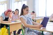 © Valerii Honcharuk - Lesson in class of teenage children, in front girl 13, 14 years old sitting at desk