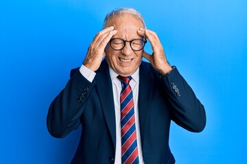 Canvas Print - Senior caucasian man wearing business suit and tie with hand on head, headache because stress. suffering migraine.