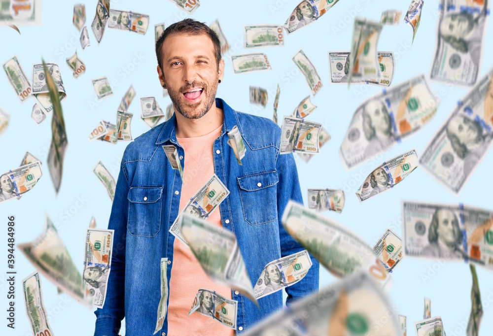 Young handsome man wearing casual clothes winking looking at the camera with sexy expression, cheerful and happy face.