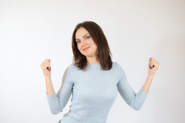 Image of excited young lady standing isolated over white background make winner gesture.