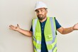 © Krakenimages.com - Handsome man with beard wearing safety helmet and reflective jacket clueless and confused with open arms, no idea and doubtful face.