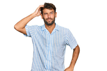 Sticker - Handsome young man with beard wearing casual fresh shirt confuse and wonder about question. uncertain with doubt, thinking with hand on head. pensive concept.