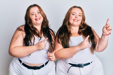 Plus size caucasian sisters woman wearing casual white clothes smiling and looking at the camera pointing with two hands and fingers to the side.