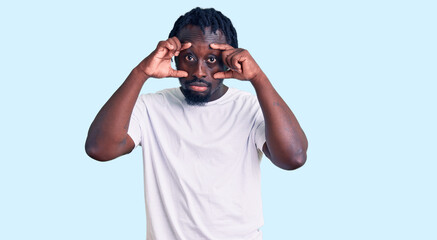 Poster - Young african american man with braids wearing casual white tshirt trying to open eyes with fingers, sleepy and tired for morning fatigue