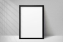 Mockup Black Frame Photo On Background Wall With Shadow. Mock Up Artwork Picture Framed. Vertical Boarder. Empty Board A4 Photoframe. Modern 3d Border For Design Prints Poster, Painting Image. Vector