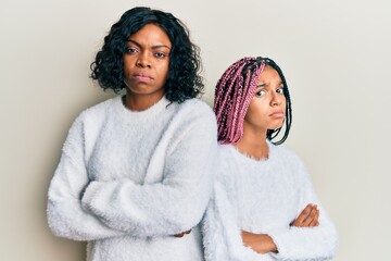 Sticker - Beautiful african american mother and daughter with arms crossed gesture depressed and worry for distress, crying angry and afraid. sad expression.