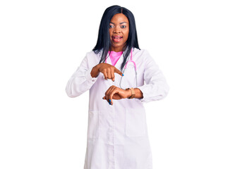 Canvas Print - Young african american woman wearing doctor stethoscope in hurry pointing to watch time, impatience, upset and angry for deadline delay