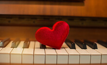 Close-up Of Red Heart Shape On Piano Key