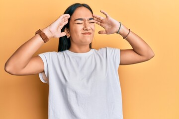 Poster - Young asian woman wearing casual white t shirt with hand on head, headache because stress. suffering migraine.