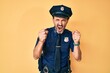 © Krakenimages.com - Middle age hispanic man wearing police uniform angry and mad raising fists frustrated and furious while shouting with anger. rage and aggressive concept.
