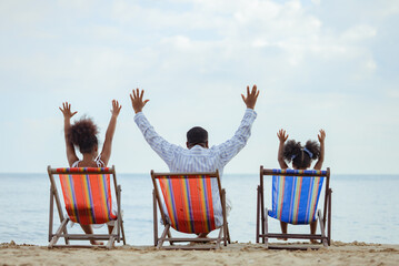 Ethnicity Happy Family Africans Enjoy relaxation resting on the beach 