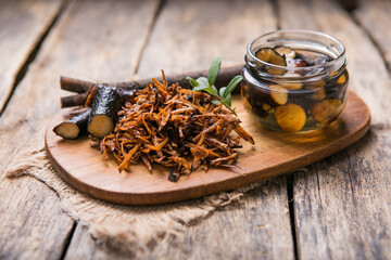 Comfrey root ( Symphytum)  on a table with honey collected in spring, on a table