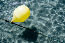 High Angle View Of Yellow Buoy Floating On Water