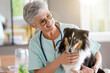 © goodluz - Cheerful veterinarian woman with dog