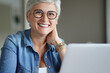 © goodluz - Portrait of a beautiful mature 50-year-old woman with white hair working from home