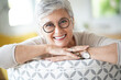 © goodluz - Portrait of a attractive smiling 55-year-old woman with white hair