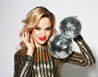 © Raisa Kanareva - Young sensual blond woman wearing evening dress and holding disco ball. Party time. Holiday concept.